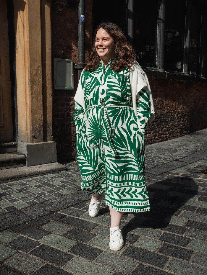 brunette woman wearing tropical print maxi dress